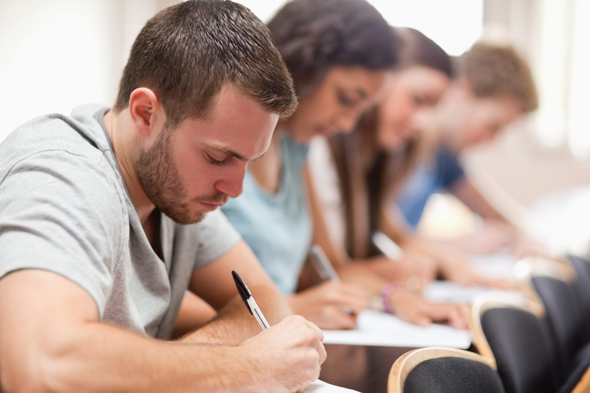 Serious,Students,Sitting,For,An,Examination,In,An,Amphitheater Testing School Admissions